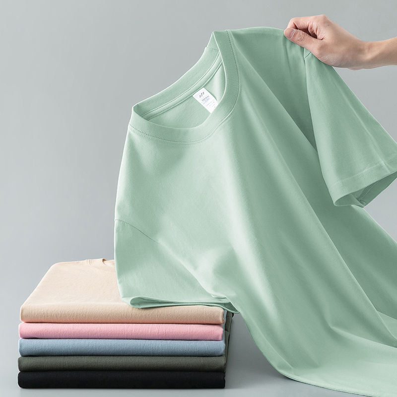 Camiseta de verano de color liso con cuello redondo y manga corta de algodón puro para hombre y mujer.